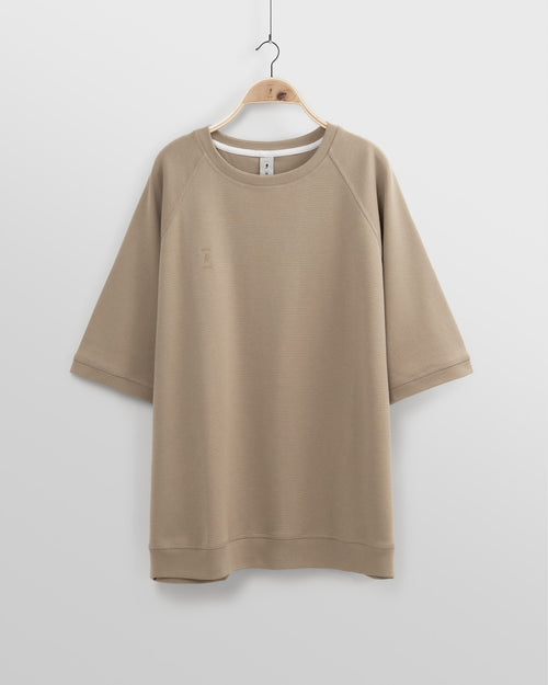 Beige sweatshirt on a hanger against a white background